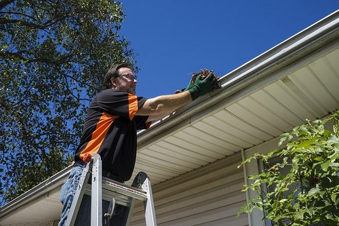 a technician fixing a damaged gutter system in Lebanon PA